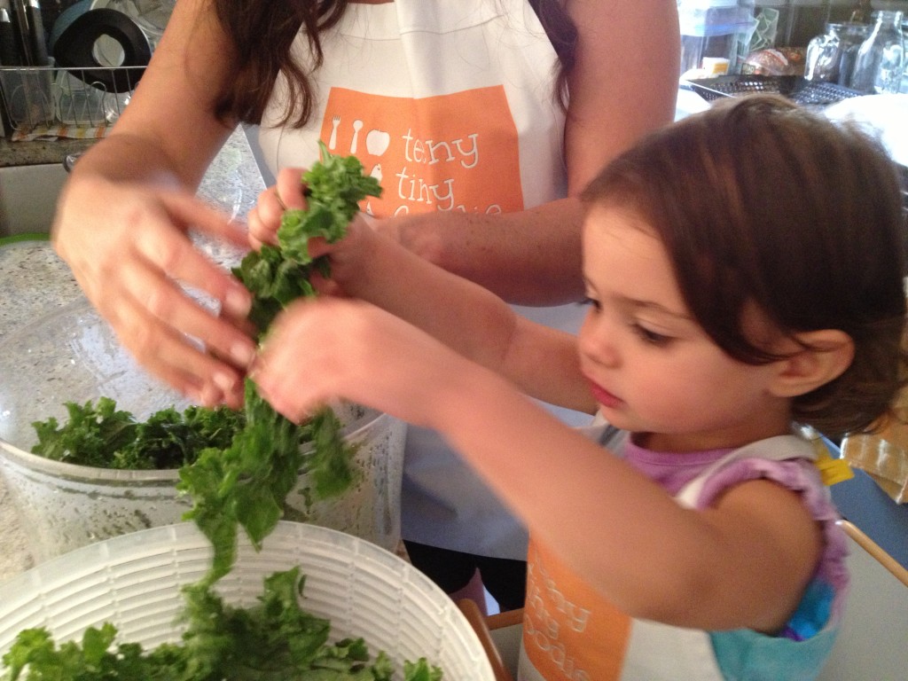 My 2 year old massaging kale