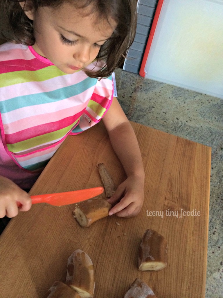 Trying to scrape the peel off a frozen banana to make a Nutty Green Smoothie from teeny tiny foodie