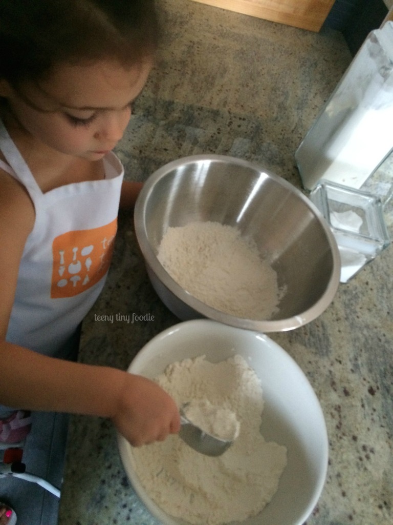 If you pour the flour into a large bowl it is easier for a toddler to scoop out and measure from teeny tiny foodie